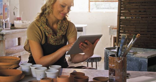 Female Artist Using Digital Tablet in Pottery Studio - Download Free Stock Images Pikwizard.com