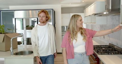 Couple touring new kitchen discussing interior design