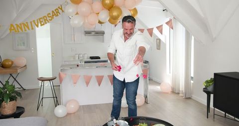 Man celebrates anniversary with romantic home decoration