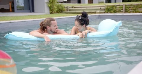 Couple Enjoying Leisure Time in Swimming Pool
