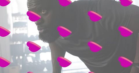 Backlit male athlete doing push-up in gym with magenta heart overlays for fitness ads