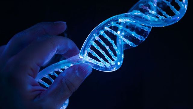 Holding glowing dna helix with neon led reflections in dark lab for genomics research
