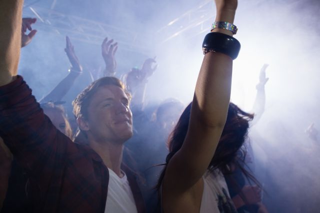 Group of people dancing at a concert in nightclub