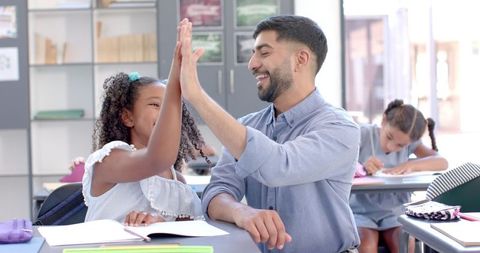 Teacher and Student Celebrating Success in Classroom High-Five - Download Free Stock Images Pikwizard.com