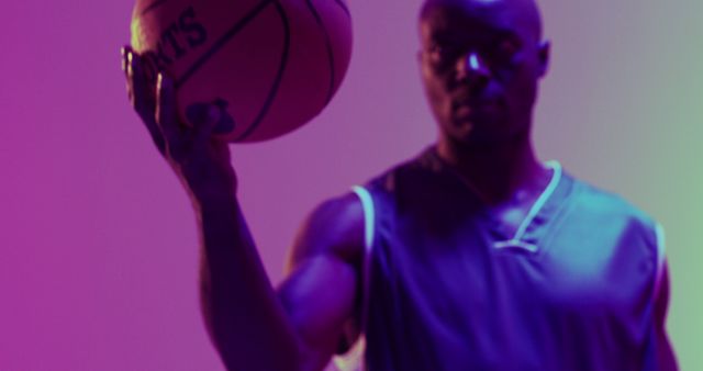 Image of african american male basketball player holding ball on purple background - Download Free Stock Photos Pikwizard.com