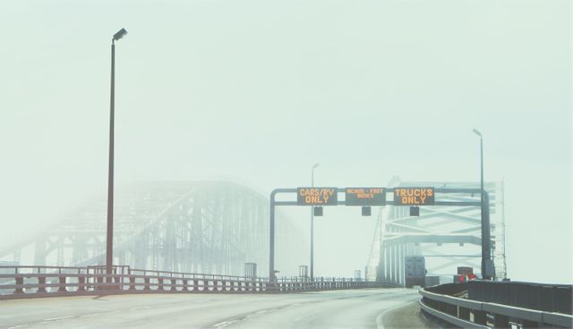 Foggy Highway Bridge with Directional Signs and Few Vehicles - Download Free Stock Images Pikwizard.com