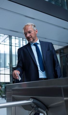 Business executive using access card to enter office building