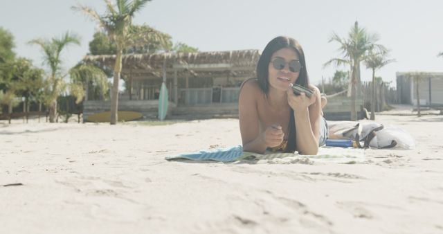 Woman Relaxing on Beach Blanket Using Smartphone in Tropical Vacation - Download Free Stock Images Pikwizard.com