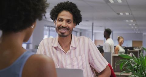 Colleague Chatting and Smiling in Bright Open-Plan Office