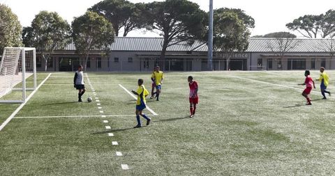 Competitive youth soccer match on sunny sports field