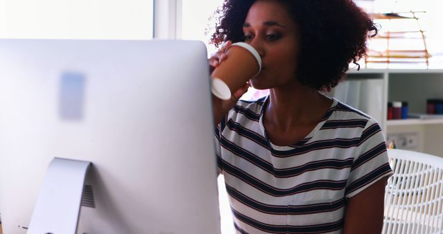 Young Woman Working at Computer Drinking Coffee at Office Desk - Download Free Stock Images Pikwizard.com