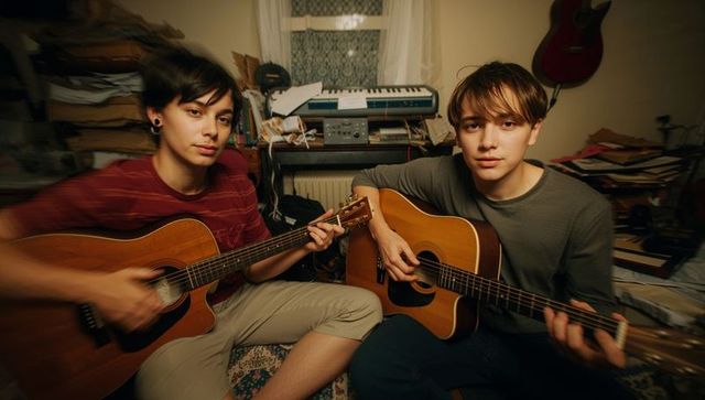 Young Musicians Playing Acoustic Guitars in Cozy Home Studio