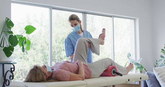 Physiotherapist Assisting Female Patient with Leg Exercises - Download Free Stock Images Pikwizard.com