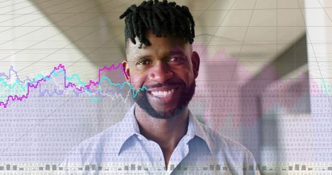 Smiling executive standing in office corridor with digital analytics overlays and code