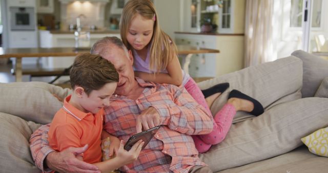 Grandfather Spending Quality Time with Grandchildren on Sofa - Download Free Stock Images Pikwizard.com