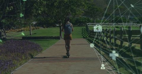 Young Woman Riding Electric Scooter Amidst Digital Network Overlay