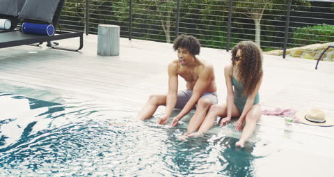 Joyous Couple Having Fun by Pool on Sunny Day