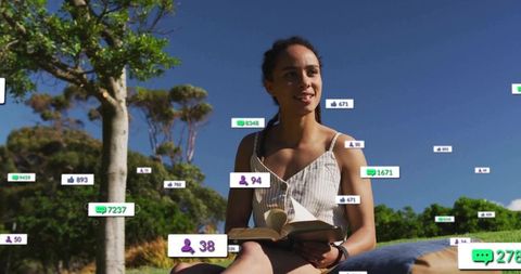 Woman Leisurely Reading Outdoors with Digital Media Visualization