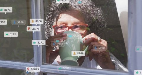 Senior Woman Enjoying Coffee Surrounded by Social Media Icons