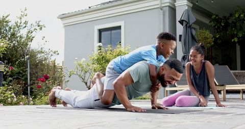 Father Enjoying Outdoor Workout with Kids in Garden