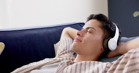 Young Man Relaxing with Headphones at Home - Download Free Stock Images Pikwizard.com
