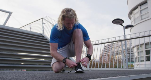 Male Runner Tying Shoes Before Outdoor Workout - Download Free Stock Photos Pikwizard.com