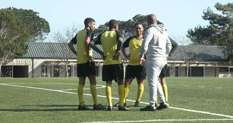 Soccer coach engaging with team during practice session