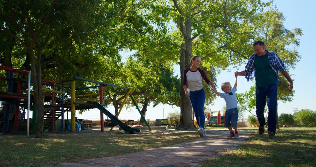 Family Strolling Through Lush Park on Sunny Day - Download Free Stock Images Pikwizard.com