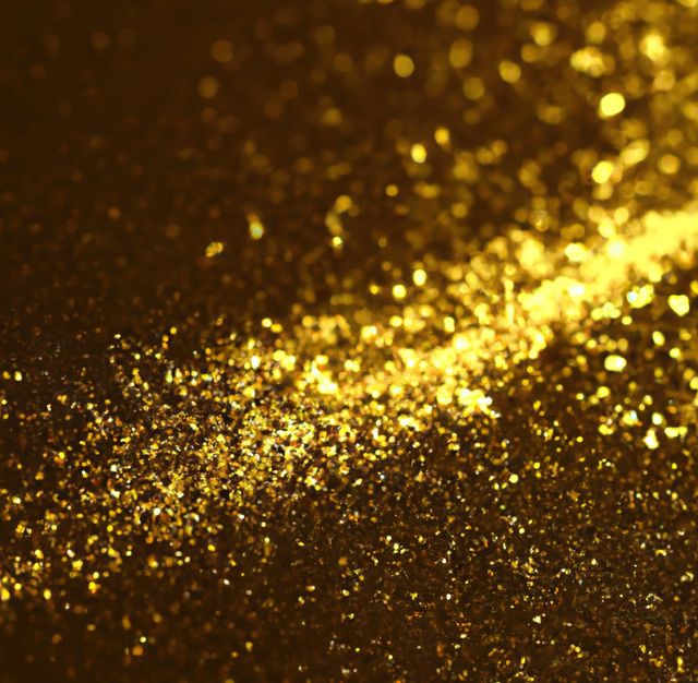 Image of close up of gold glitter particles background with copy space. Glitter, make up, colour and glamour concept.