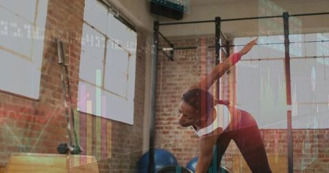 Woman Stretching and Bending in Industrial Gym with Digital Data Visualization Overlays