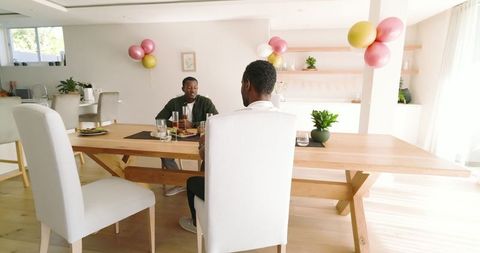 Friends Dining Together in Bright Modern Living Room