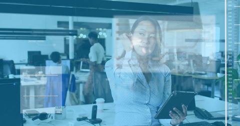 Busy Asian Businesswoman Using Digital Tablet in Modern Office Environment