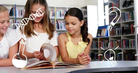 Elementary students exploring book together in bright library with science idea doodles