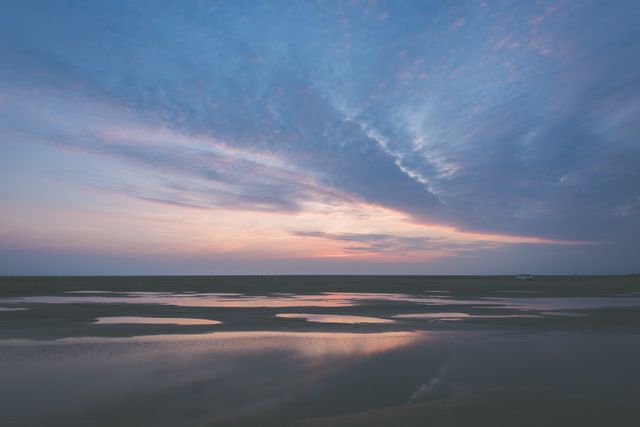 Serene Twilight over Tranquil Beach with Reflective Tidal Pools - Download Free Stock Photos Pikwizard.com