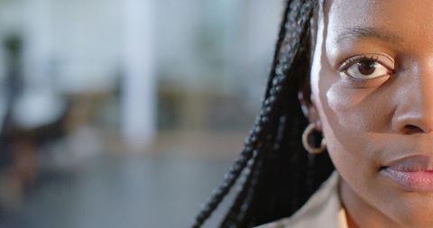 Confident African-American Professional Half-Face Headshot Braids Earring Office Bokeh
