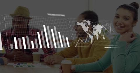 Smiling woman holding coffee pointing at graphs with world map data overlay in meeting
