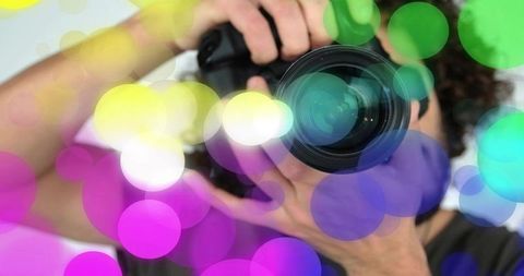 Photographer adjusting dslr lens with vibrant bokeh overlay