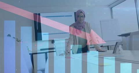 Businesswoman in hijab analyzing downward financial trends