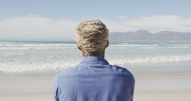 Man with Curly Hair Wearing Blue Shirt at Seaside - Download Free Stock Images Pikwizard.com