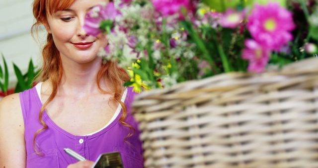 Female Florist Taking Notes in Bright Flower Shop - Download Free Stock Images Pikwizard.com