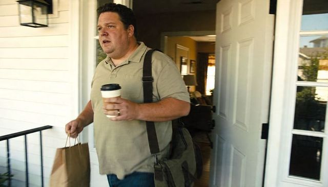 Stepping out with coffee and paper bag through open front door suburban morning errand