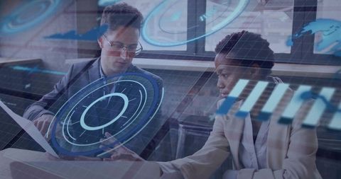 Business colleagues analyzing augmented reality data dashboards on laptop in modern office