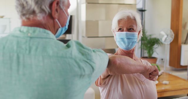 Happy Elderly Friends Greeting with Elbow Bump While Wearing Masks - Download Free Stock Images Pikwizard.com