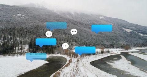 Augmented reality chat bubbles floating over snowy alpine valley with meandering river