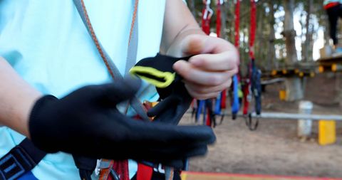 Person prepares for outdoor adventure with safety gear