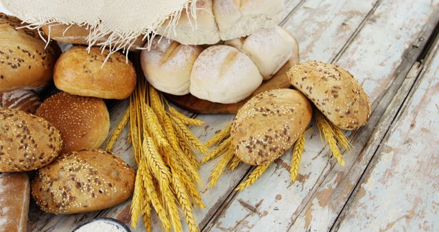 Assortment of Freshly Baked Bread and Wheat on Rustic Wooden Table - Download Free Stock Images Pikwizard.com