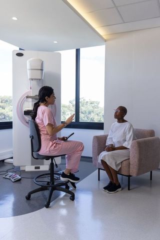 African-American Clinician Consulting Patient Before Mammogram in Modern Radiology Clinic