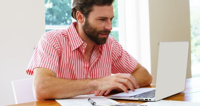 Man Working on Laptop at Home Office Desk in Daylight - Download Free Stock Images Pikwizard.com