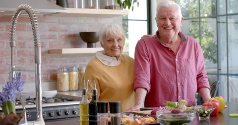 Happy Senior Couple Enjoying Cooking Together at Home