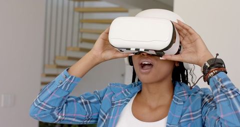 Enthusiastic Woman Experiencing Virtual Reality Indoors